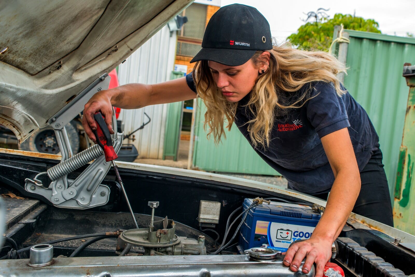 Madeline Moore fixing a car