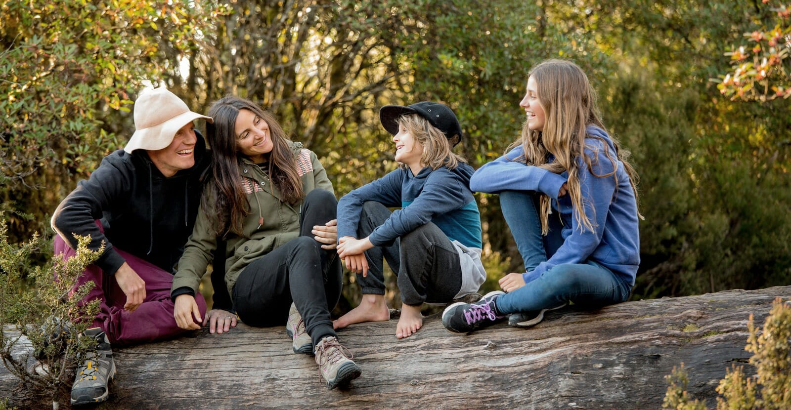 The Woods family on a rock