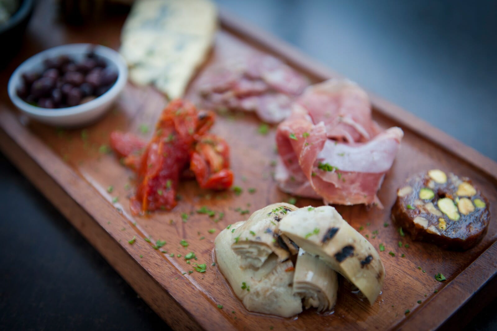 Deli food on a chopping board pansabella