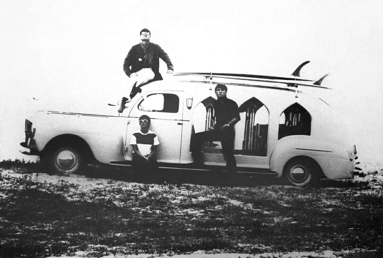 Paul Witzig on the top of an old hearse.
