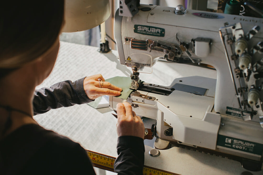 Amy Smith on her sewing machine making swimwear