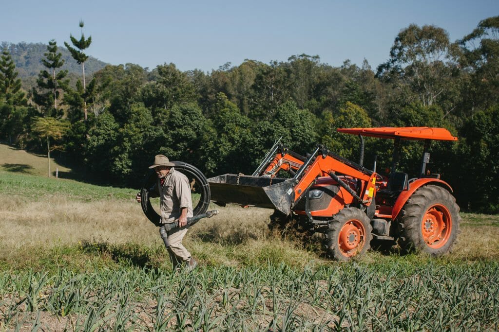 Marcus in the paddock with a tractor.