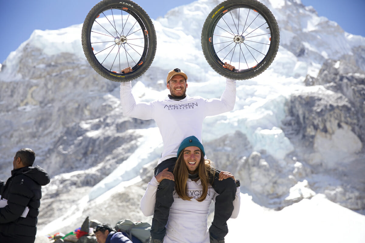 Scott Doolan holds up his wheels from the trip