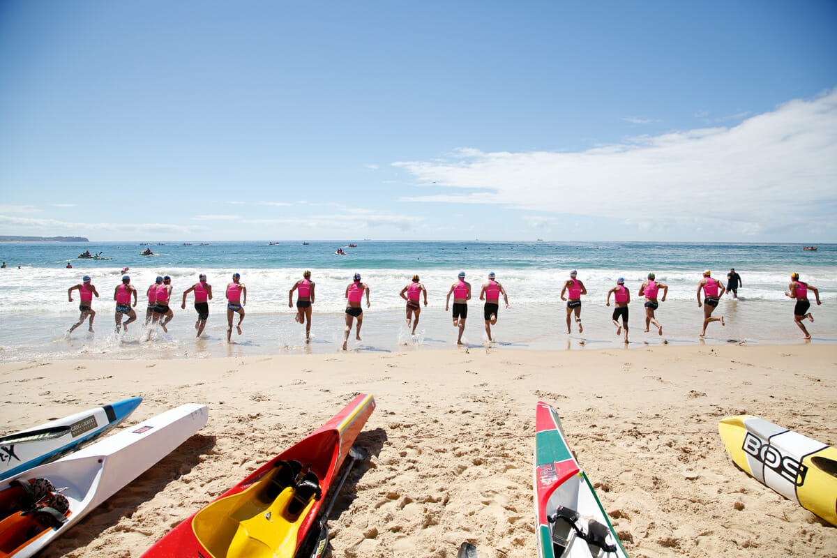 Surf Life Savers run into the ocean