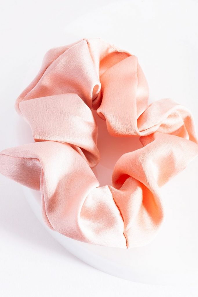 A light pink Lovisa Silk Scrunchie from Port Central.