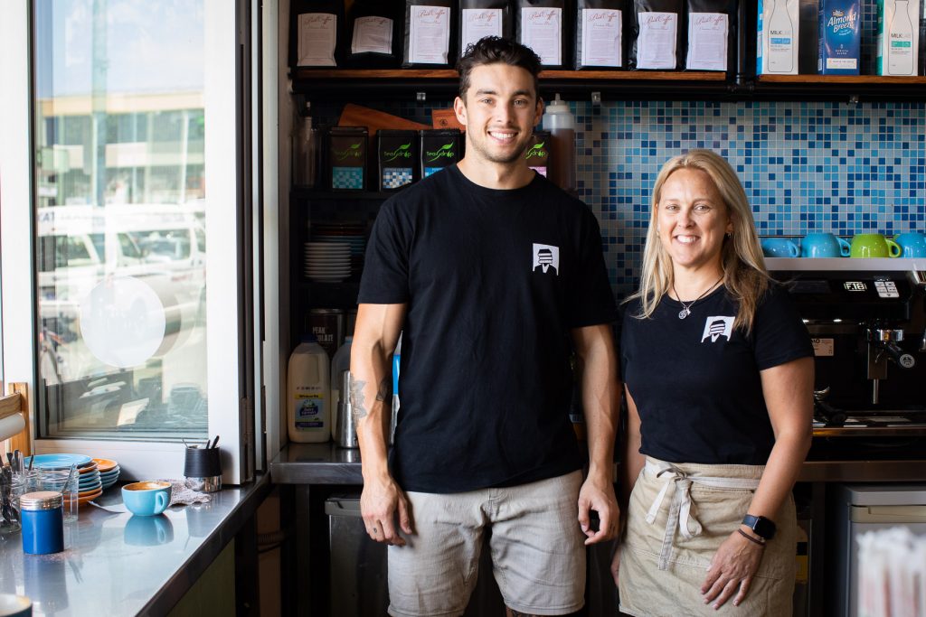 Jo and Makes Hawes stand side by side smiling at Bookface Cafe Port Central 