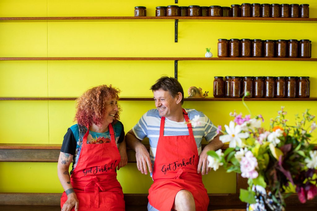 Mauz and Marty sit in front of Marty's Mongrel Marmalade at Fork Knows Plant Based Eatery 