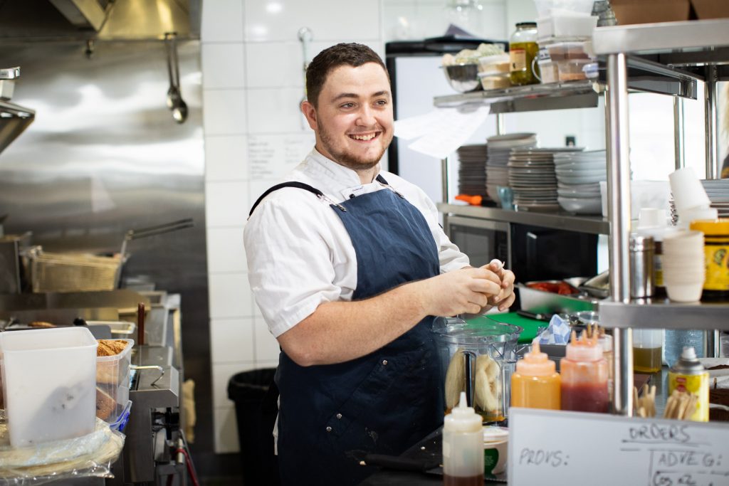 The chef at Hub Cafe prepares food in the kitchen 