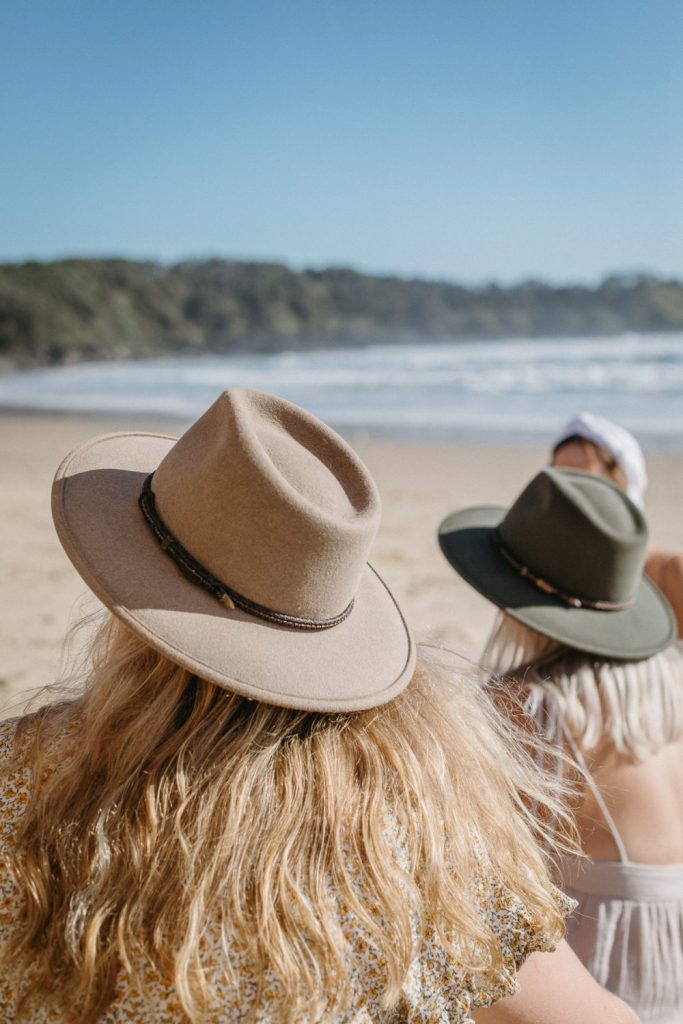 Women wearing Akubra hats on the beach