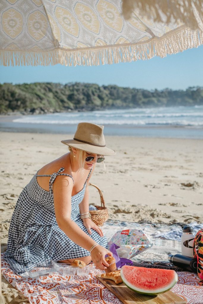 Woman on a beach wearing an Akubra hat