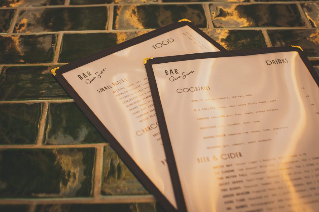 The menu on green tiles at Bar Que Sera Sawtell 