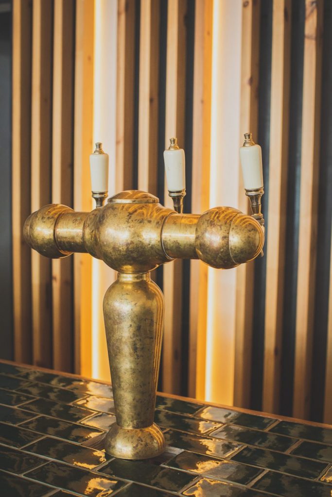 Gold taps on the bar at Bar Que Sera Sawtell 