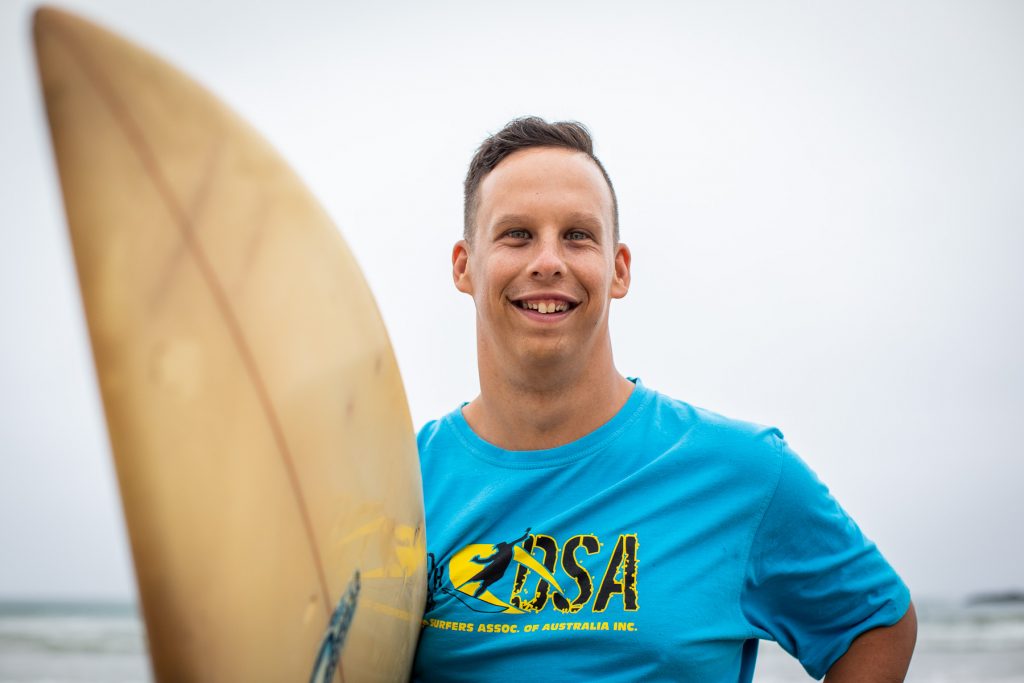 Close up of Jordy Davis holding a surfboard