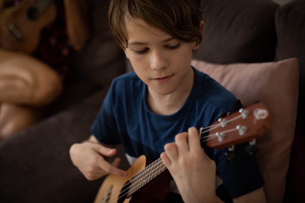 Close up of Keiran Porter playing the ukulele