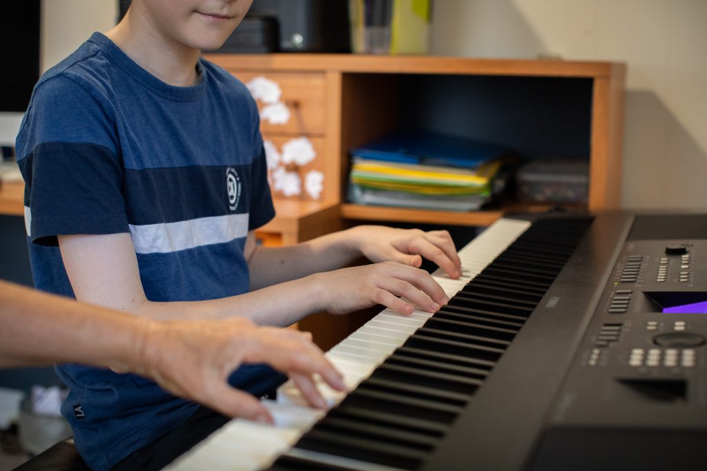 Close up of Keiran Porter playing piano