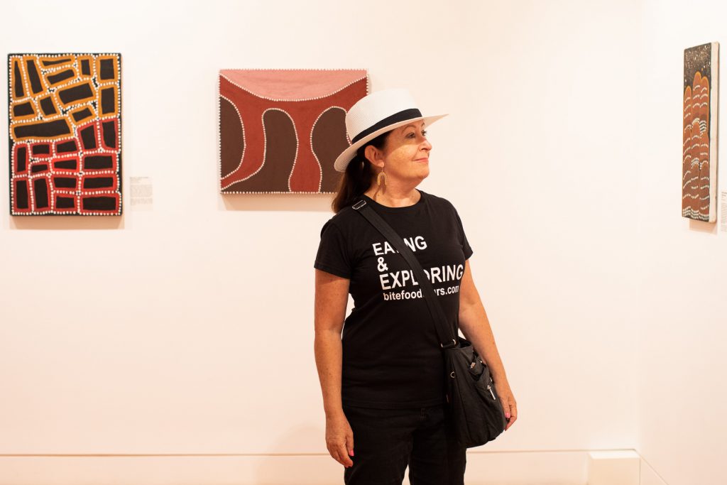 Mid shot of Awia Markey looking at artworks in the Coffs Harbour Regional Gallery