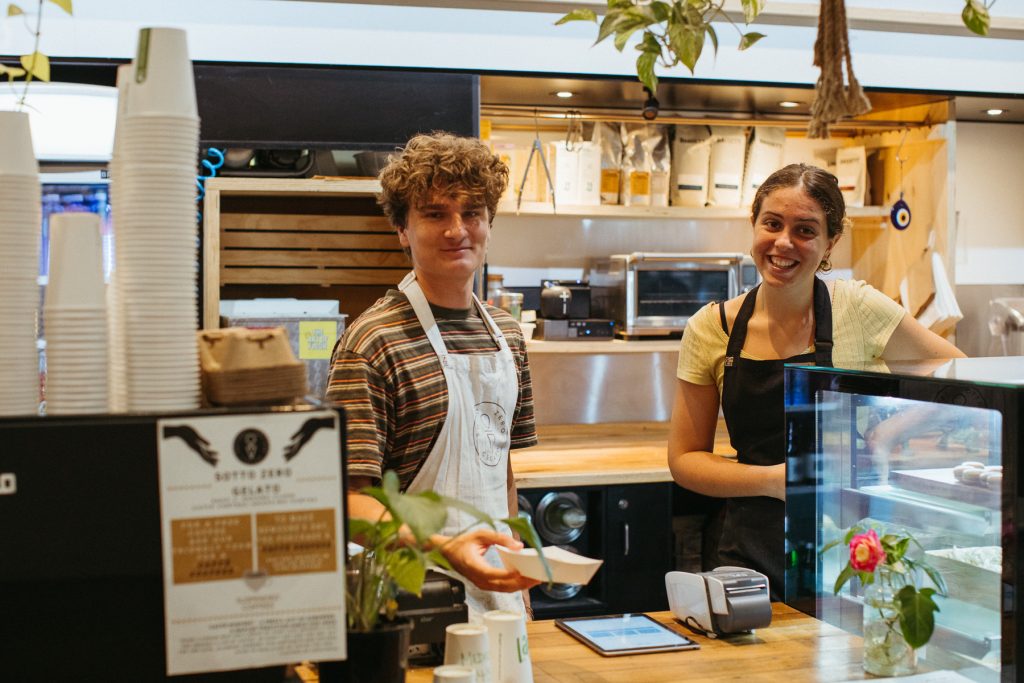 Mid shot of two young people behind the counter at Sotto Zero Coffs Central 