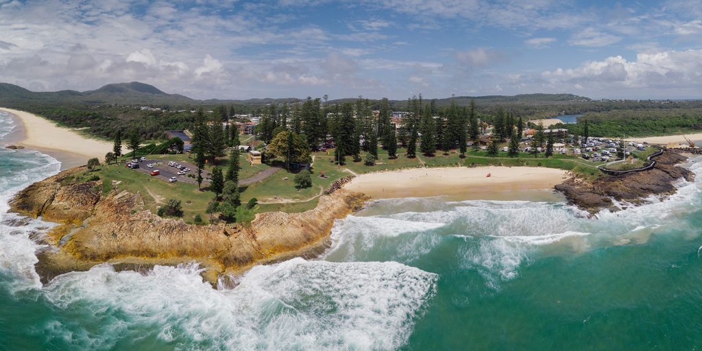 Aerial shot of South West Rocks  headland and ocean 