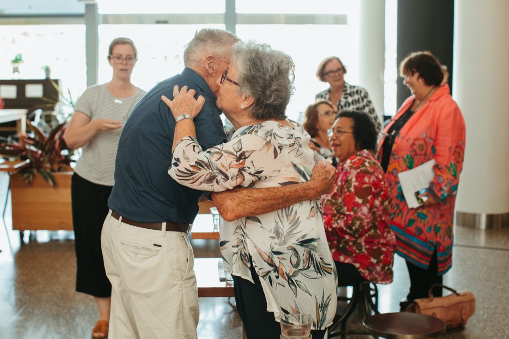 Two elderly people embracing 