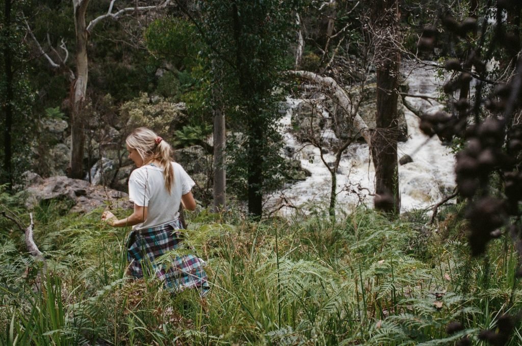 Woman bushwalking by a swimming hole