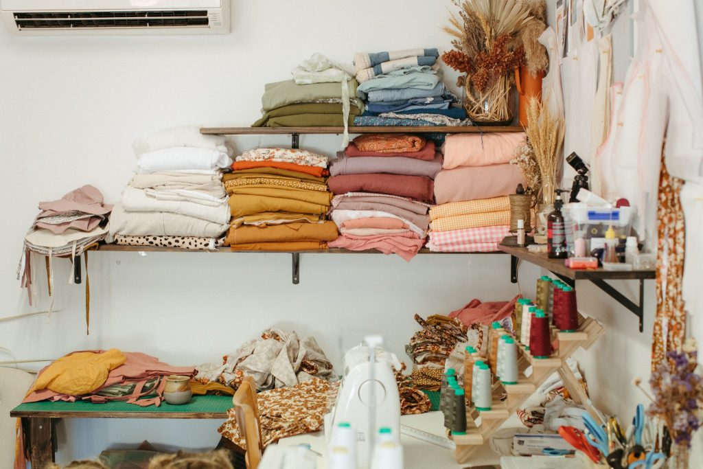 Stacks of coloured fabric and a sewing machine