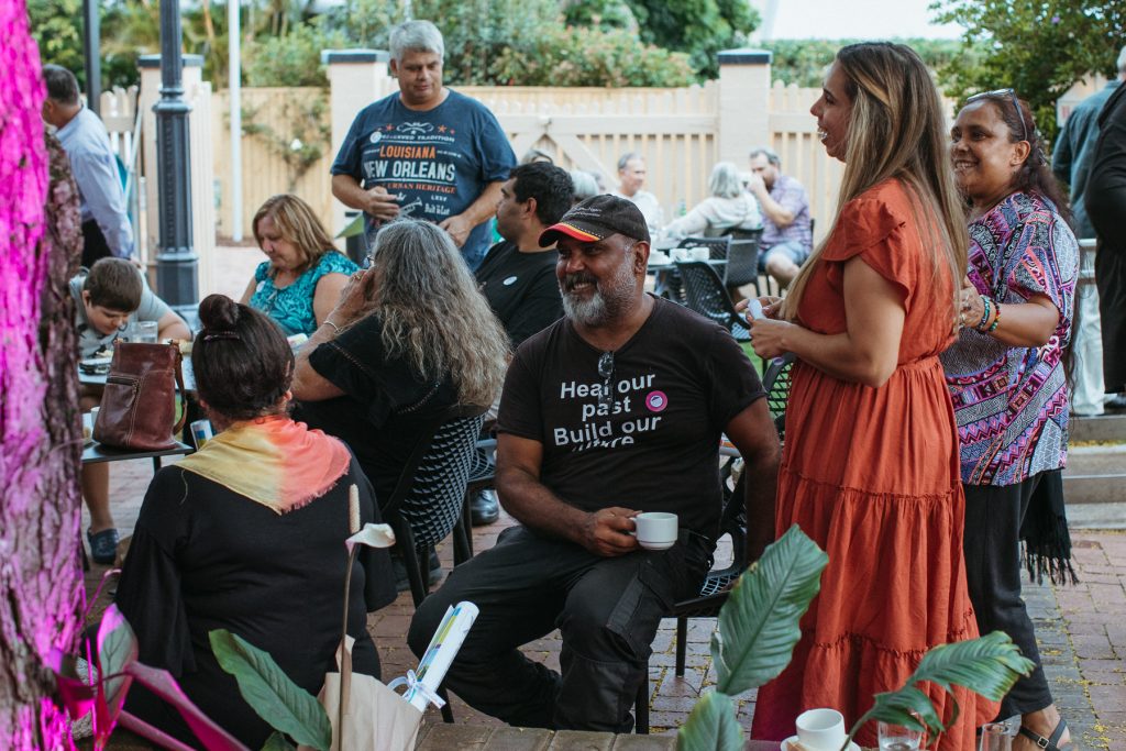 A group of Aboriginal people talk and laugh together