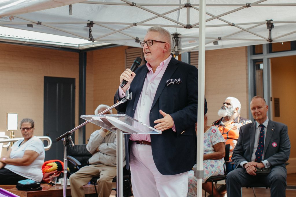 The NSW Arts Minister Don Harwin speaks at a podium in front of a crowd