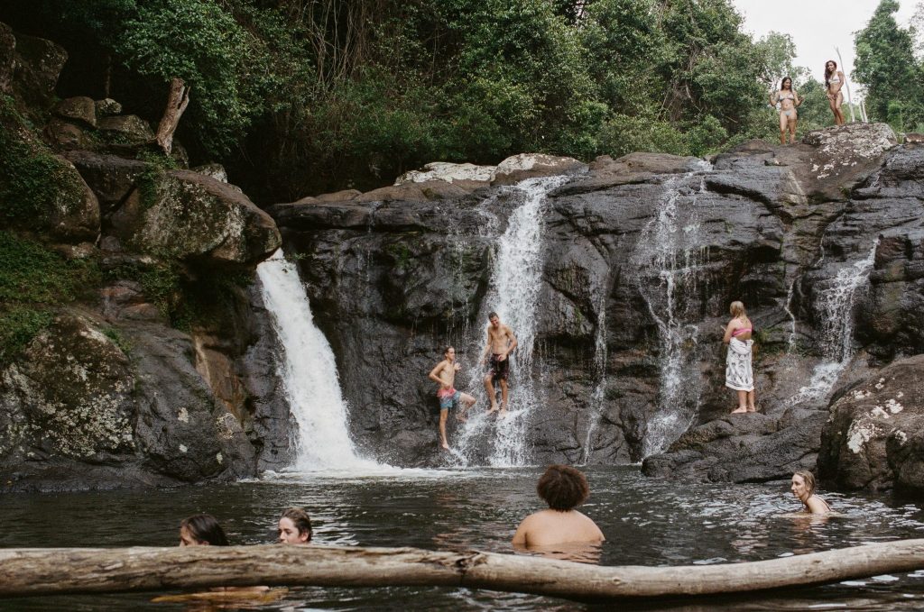 A group of people swimming in a water hole