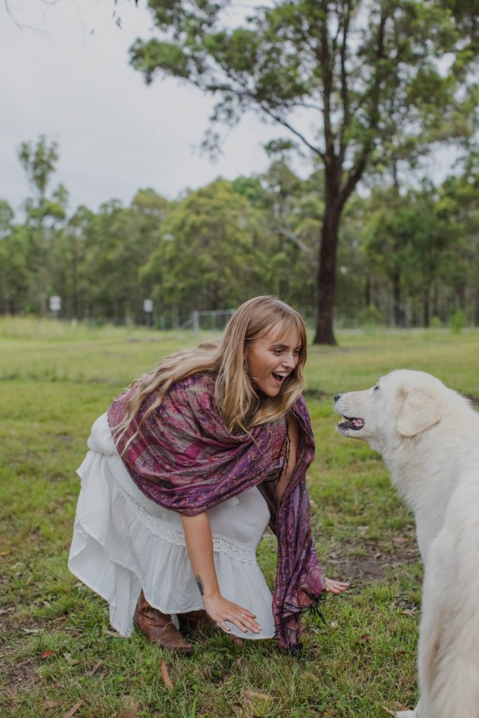 A young woman and a sheepdog