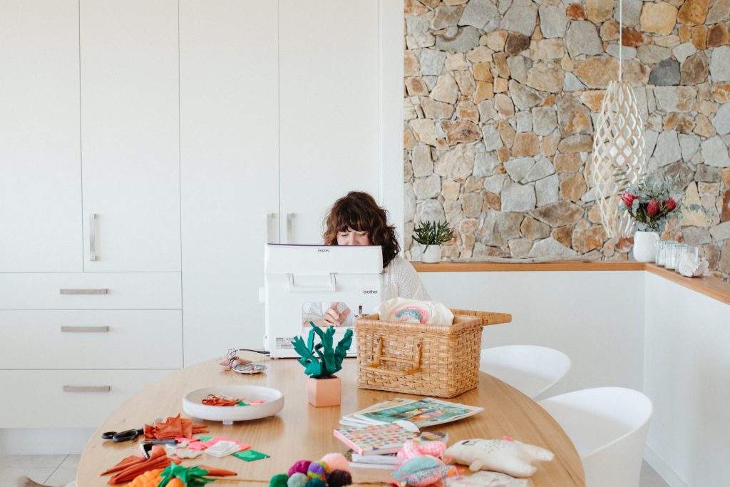 A woman sitting behind a sewing machine 