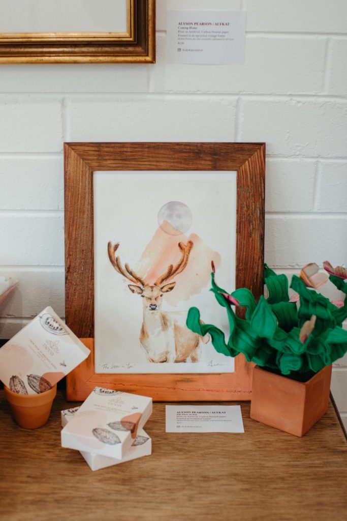 A framed illustration of a deer