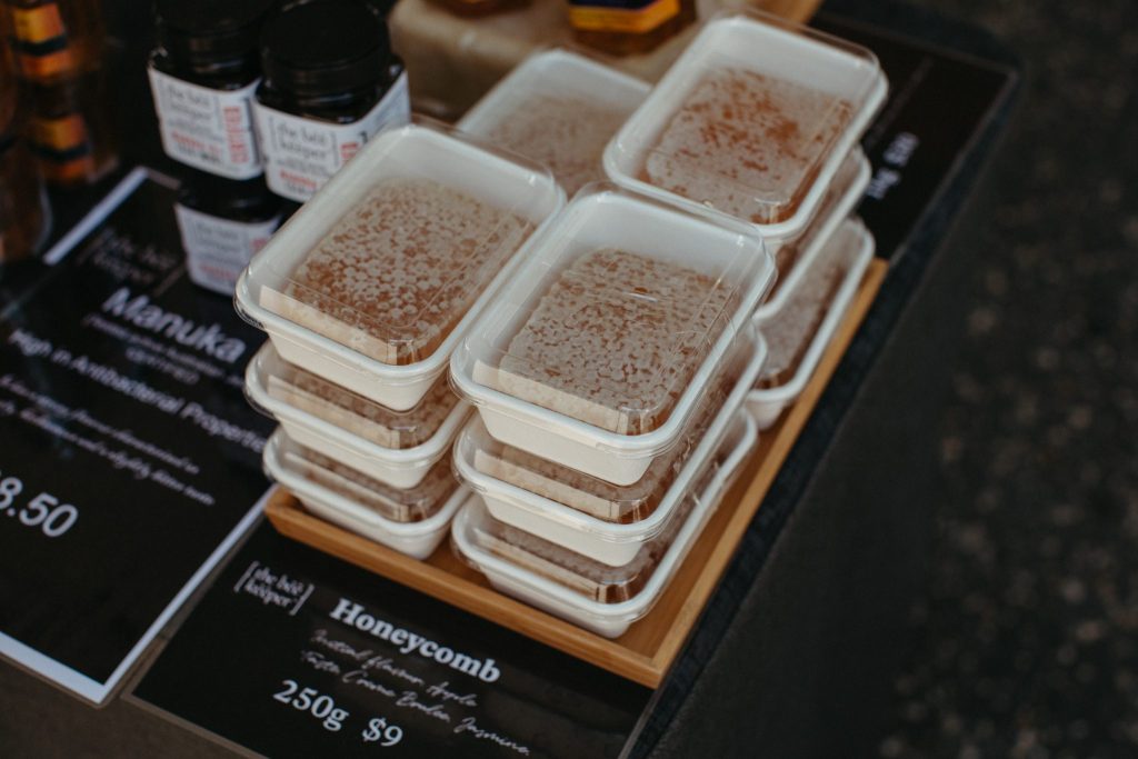 Honeycomb stacked up in boxes on a table.