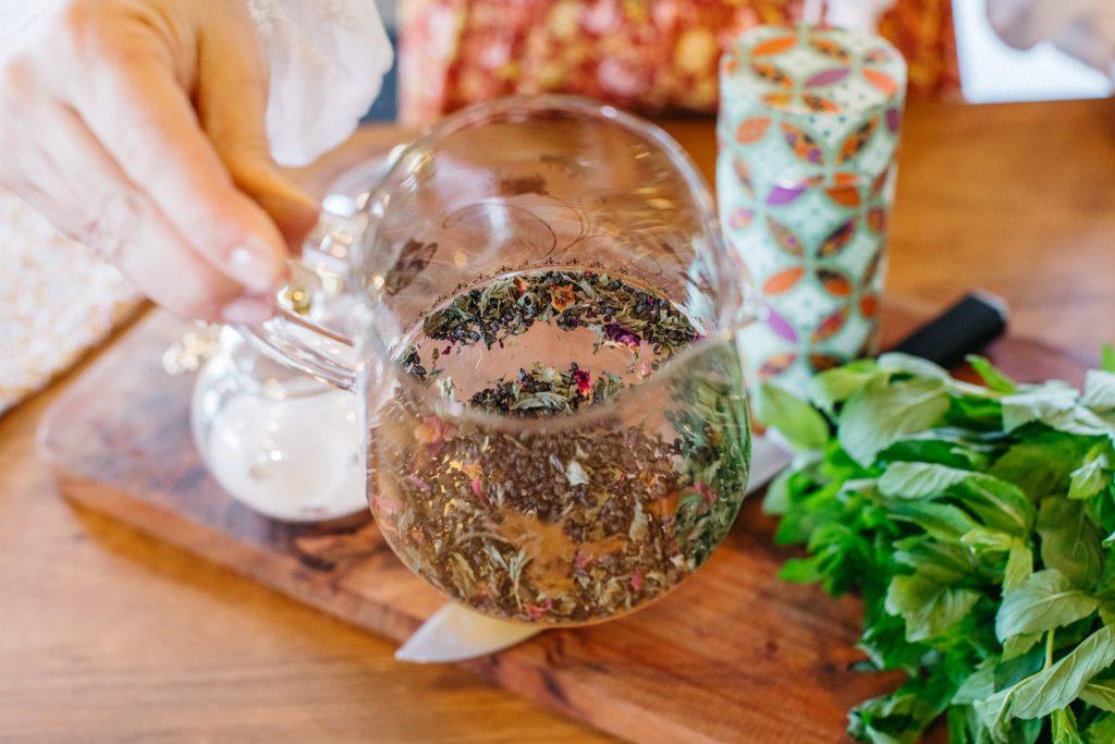 Close up of a glass teapot with tea leaves inside