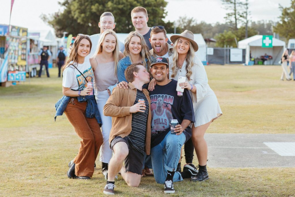 Nine young people gathered together at a music festival