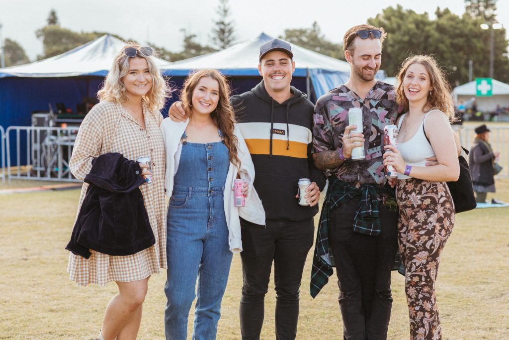 Five young people gathered together at a music festival