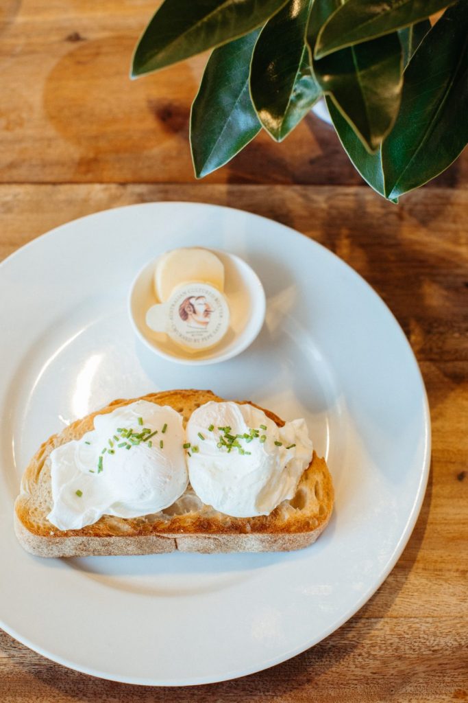 Top down shot of two poached eggs on a piece of sourdough toast