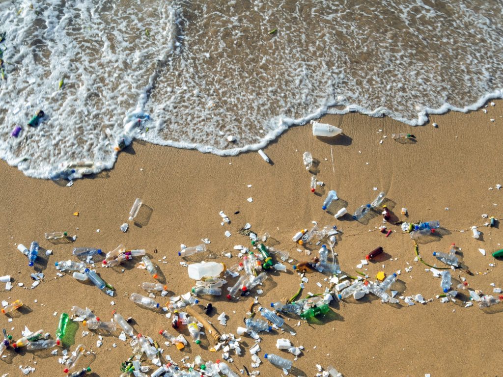 Used plastic bottles on the sand on a beach