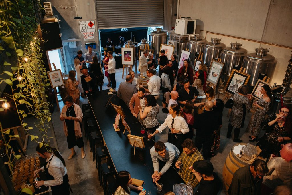A crowd of people in a vodka distillery