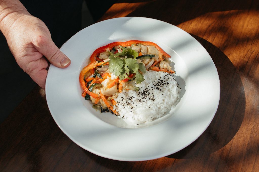 A chicken satay dish with rice at Cocoa Cafe