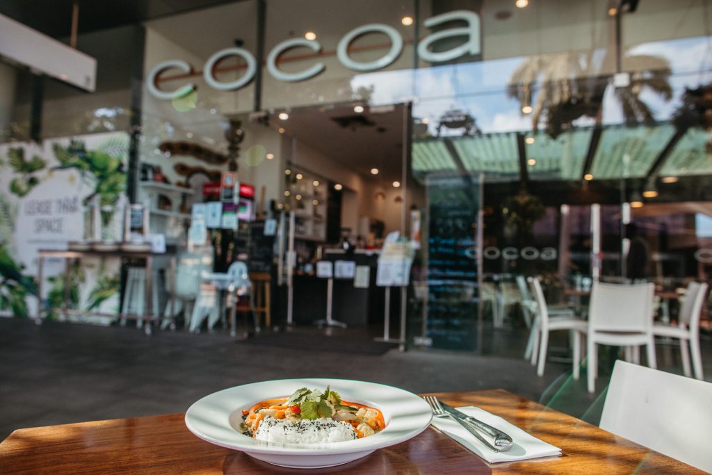 A chicken satay dish on a table outside Cocoa Cafe