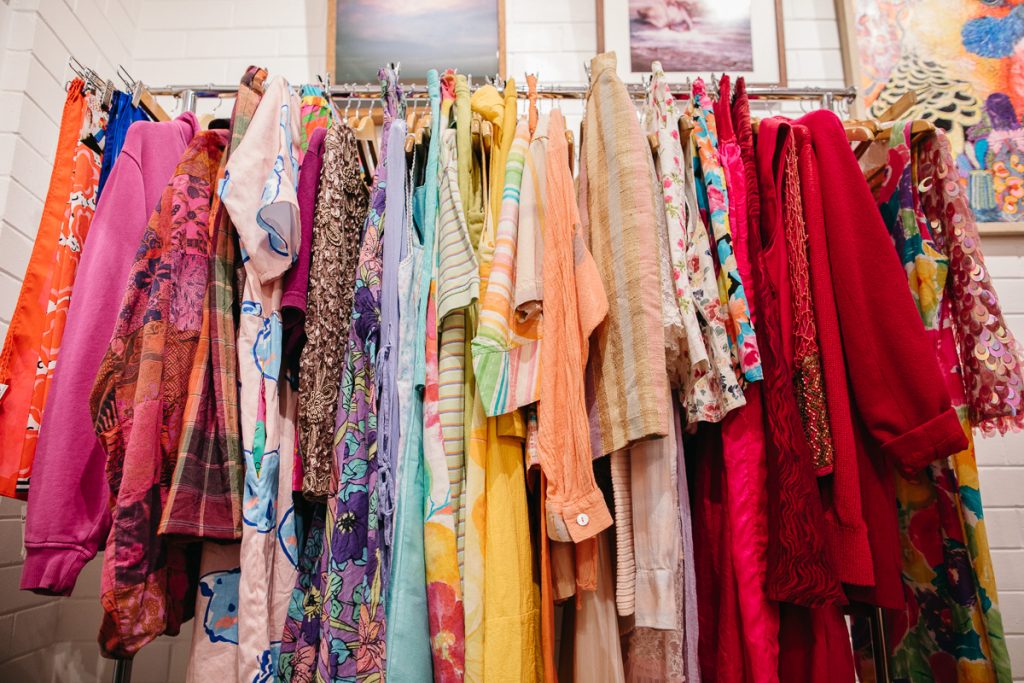 A rack of colourful vintage clothes