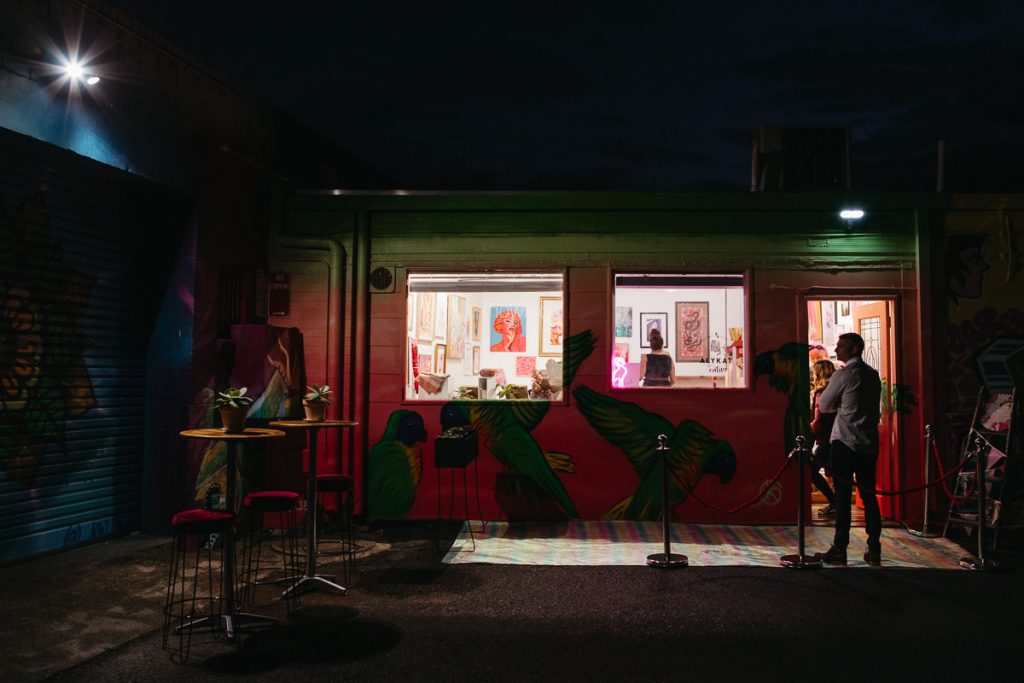 The exterior of a colourful art gallery at night