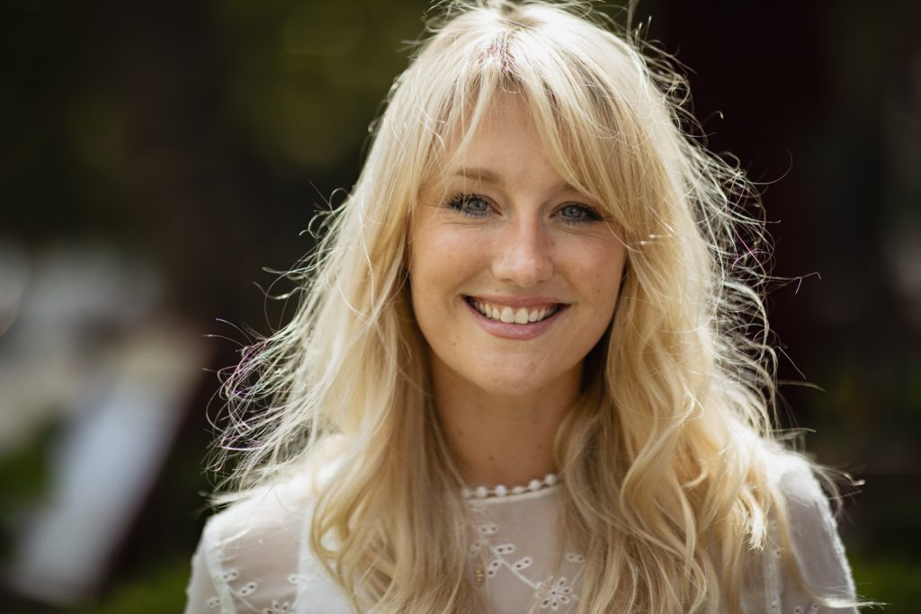 A blonde woman with curtain bangs