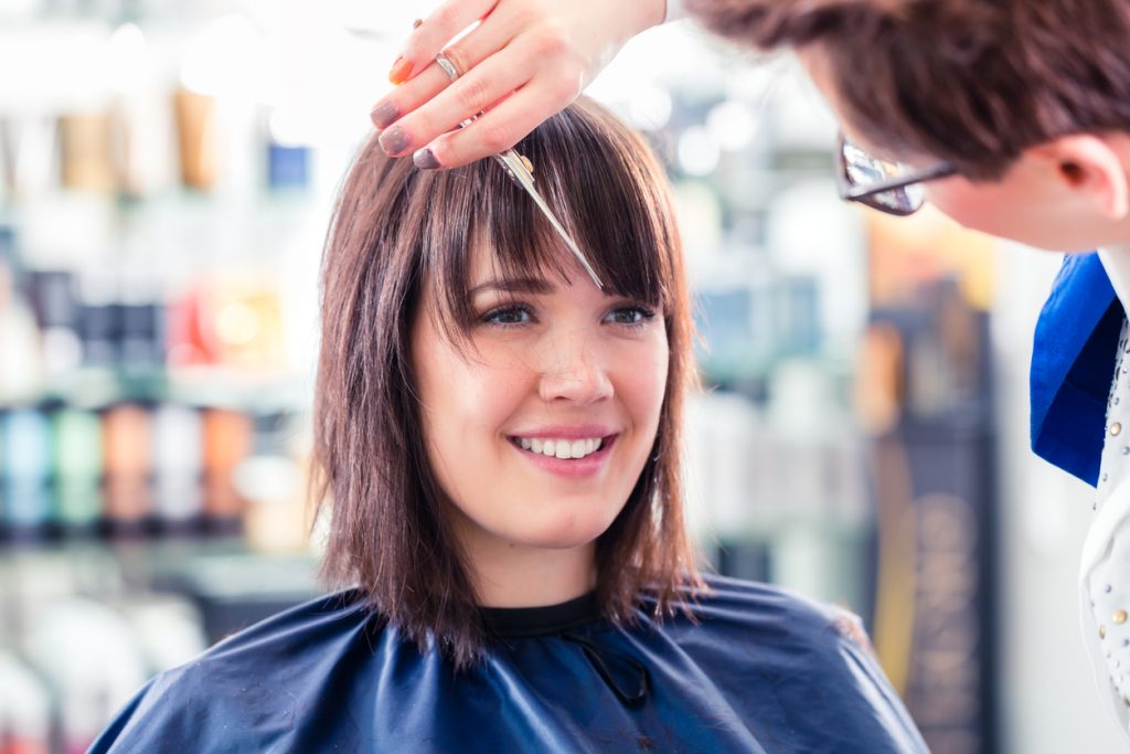 A woman having her hair cut