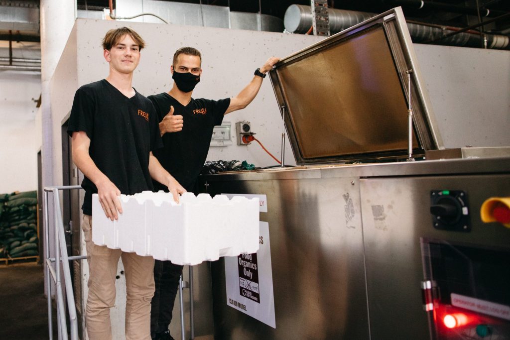 Fresco staff using the compost machine at Coffs Central